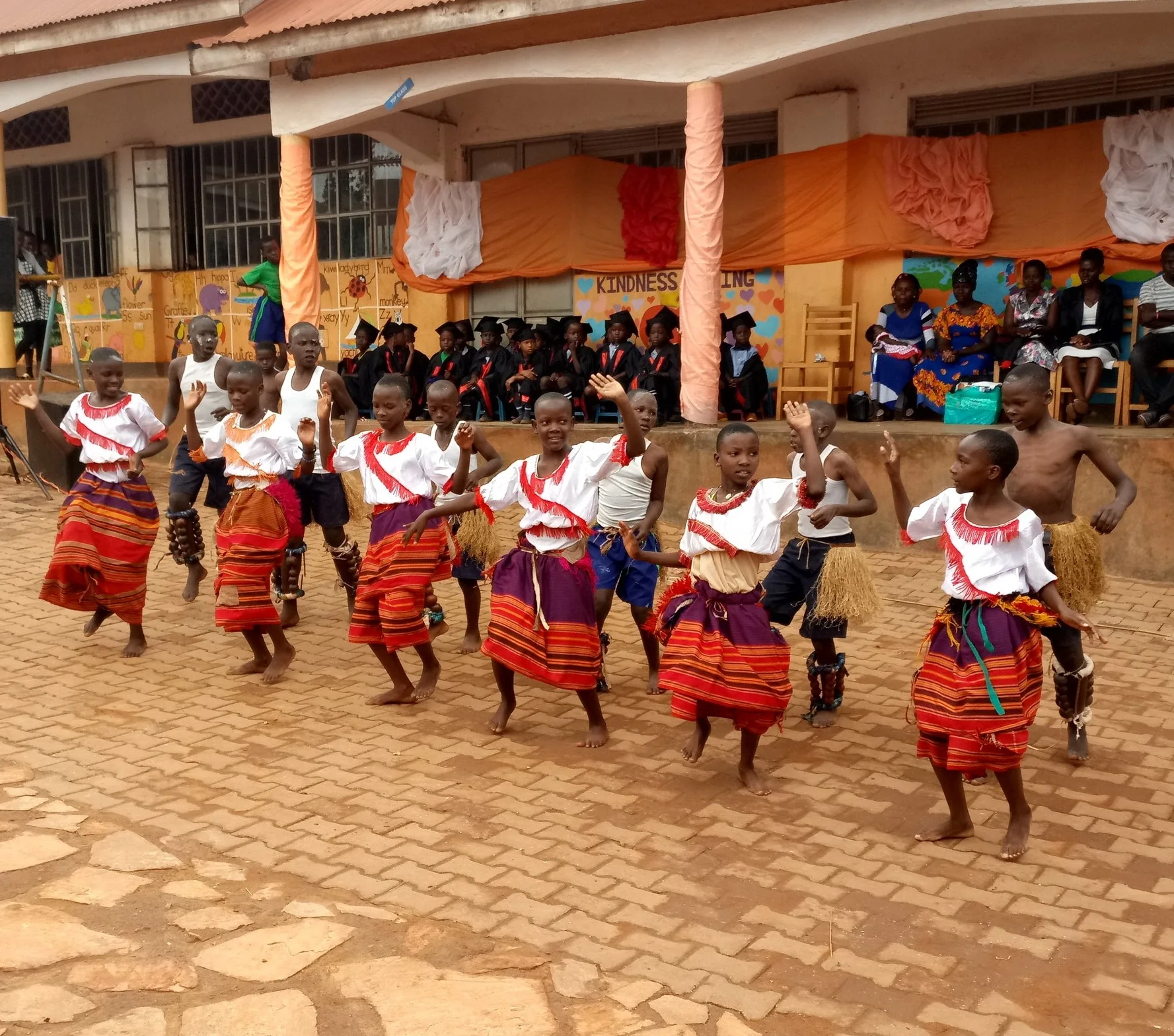 Students dancing in colorful clothing in the school courtyard